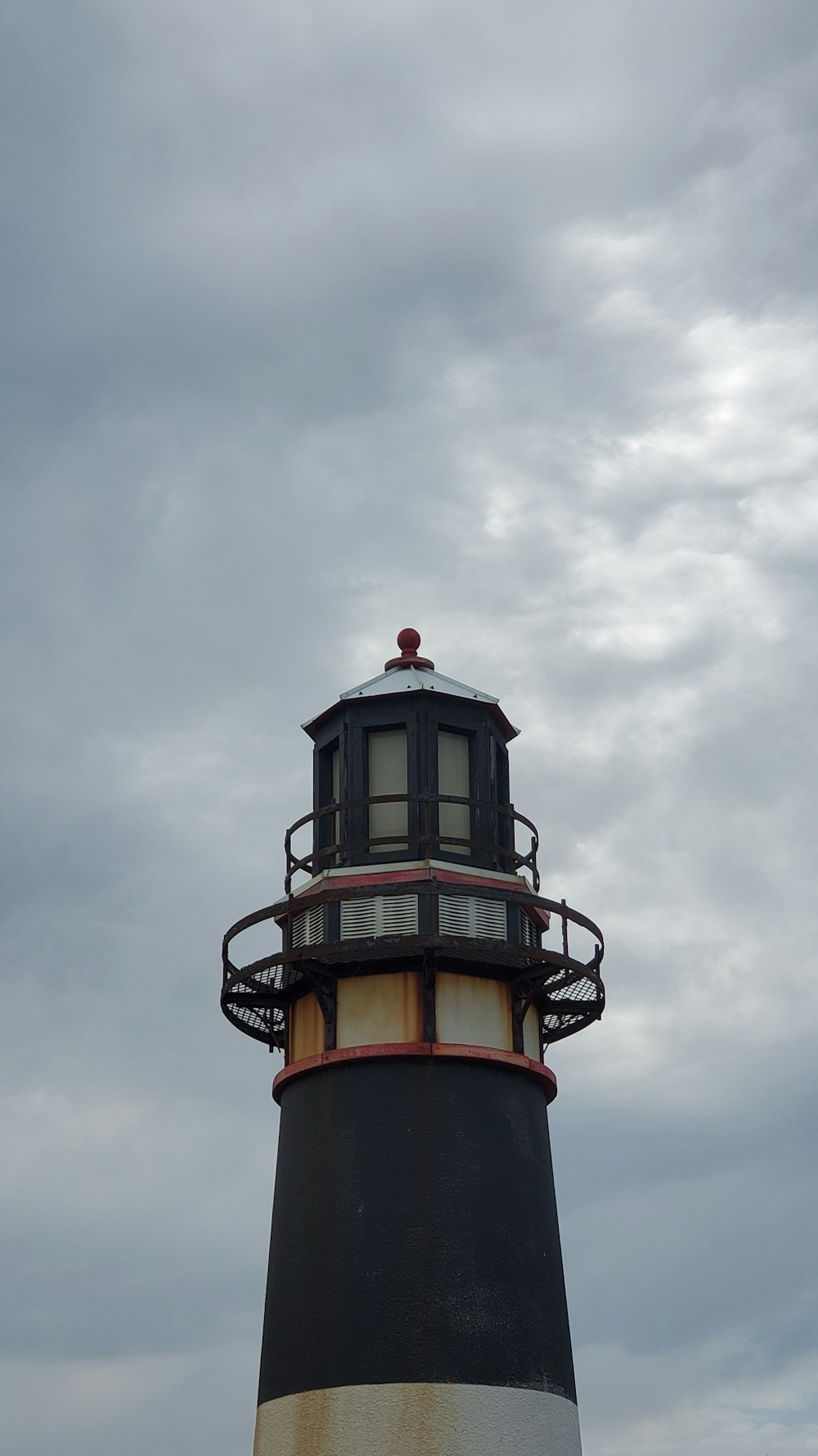 red and white tower under cloudy sky