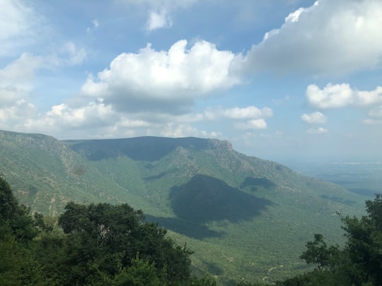 green mountain under blue sky during daytime in Sathyamangalam India