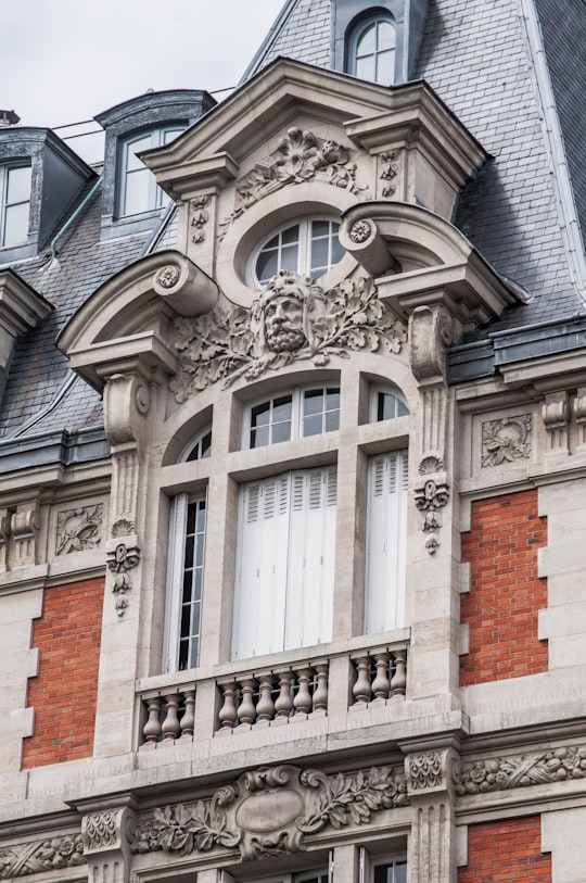 brown brick building with gray windows in 6e Arrondissement de Paris France