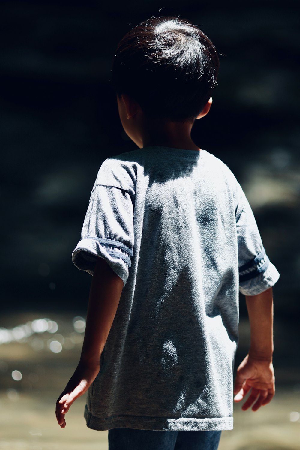 boy in grey crew neck t-shirt standing