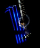 An AHX baritone guitar with LED-illuminated fretboard in a studio setting.