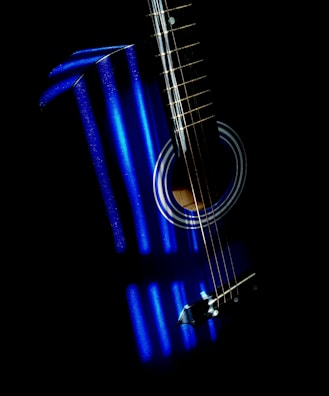 An AHX baritone guitar with LED-illuminated fretboard in a studio setting.