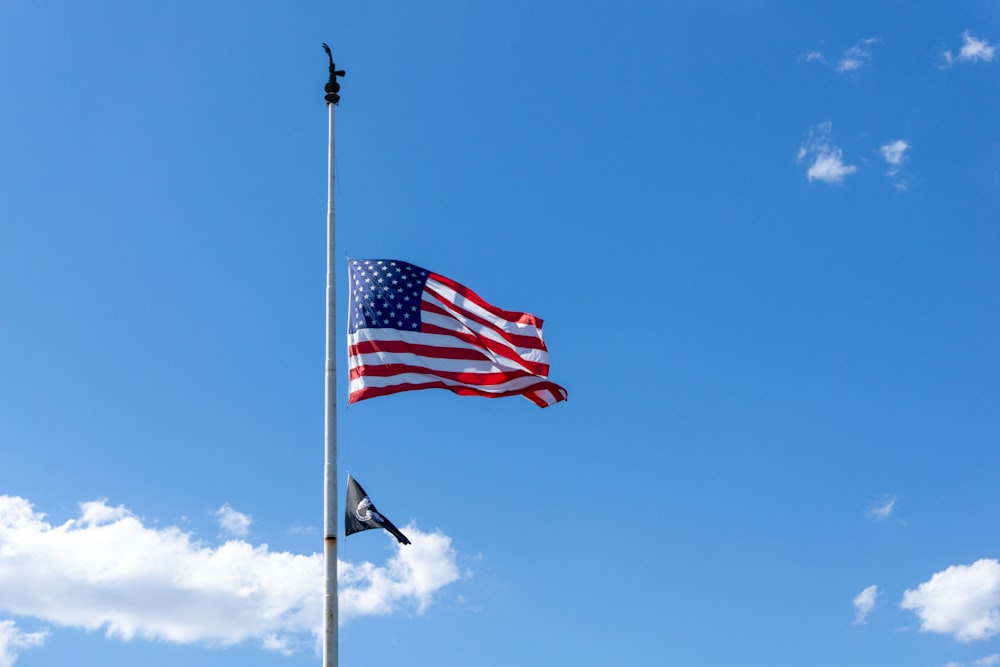 us a flag on pole under blue sky during daytime