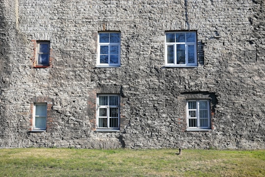 brown brick building with white wooden window in Towers' Square Estonia