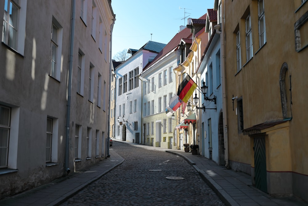 empty street between concrete buildings during daytime