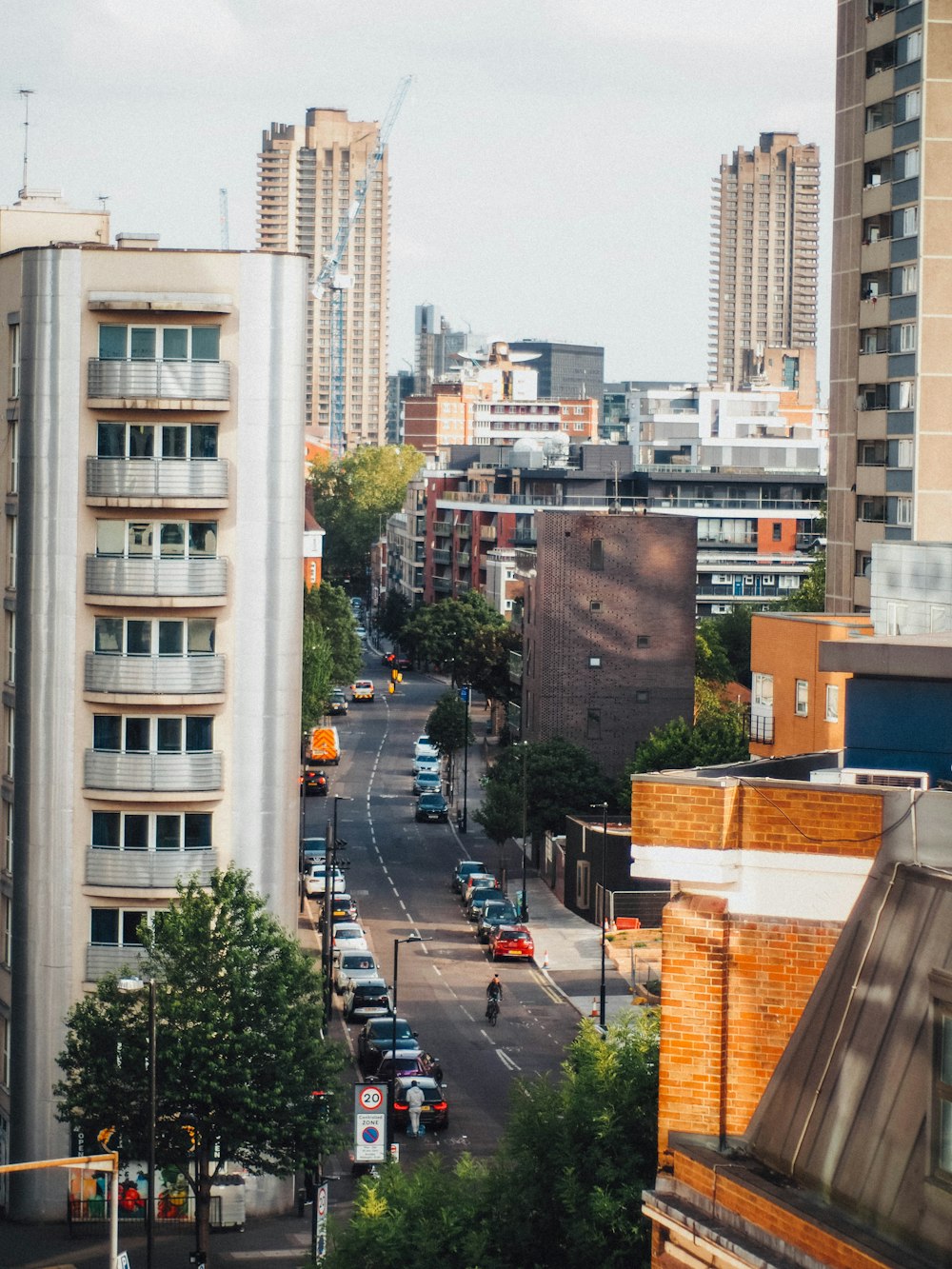 cars on road near high rise buildings during daytime