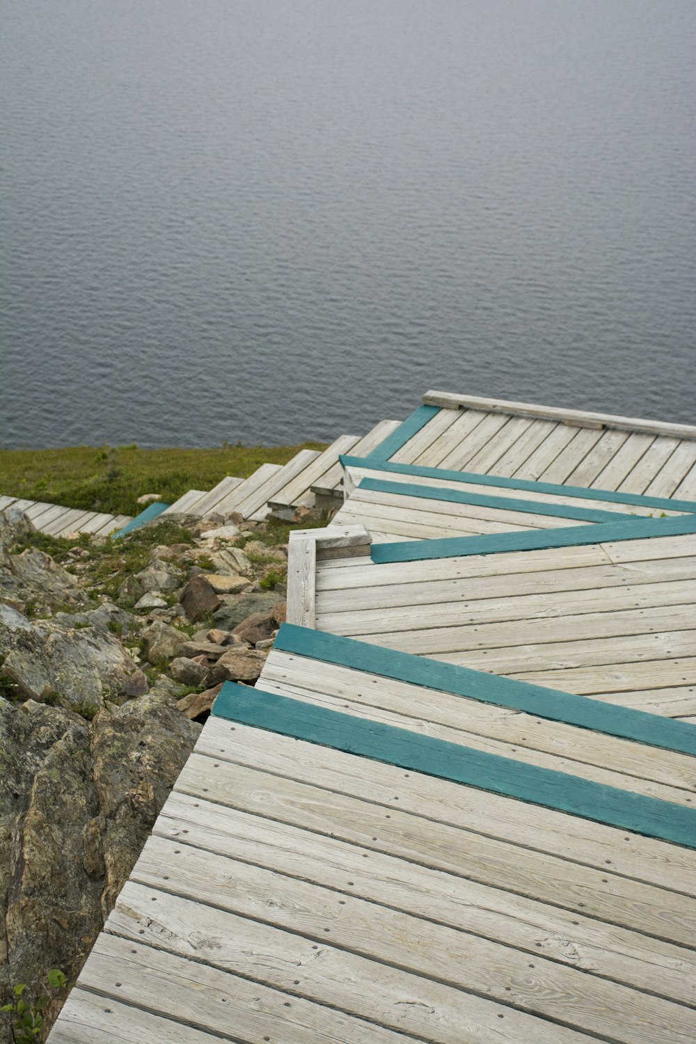 brown wooden dock on body of water during daytime