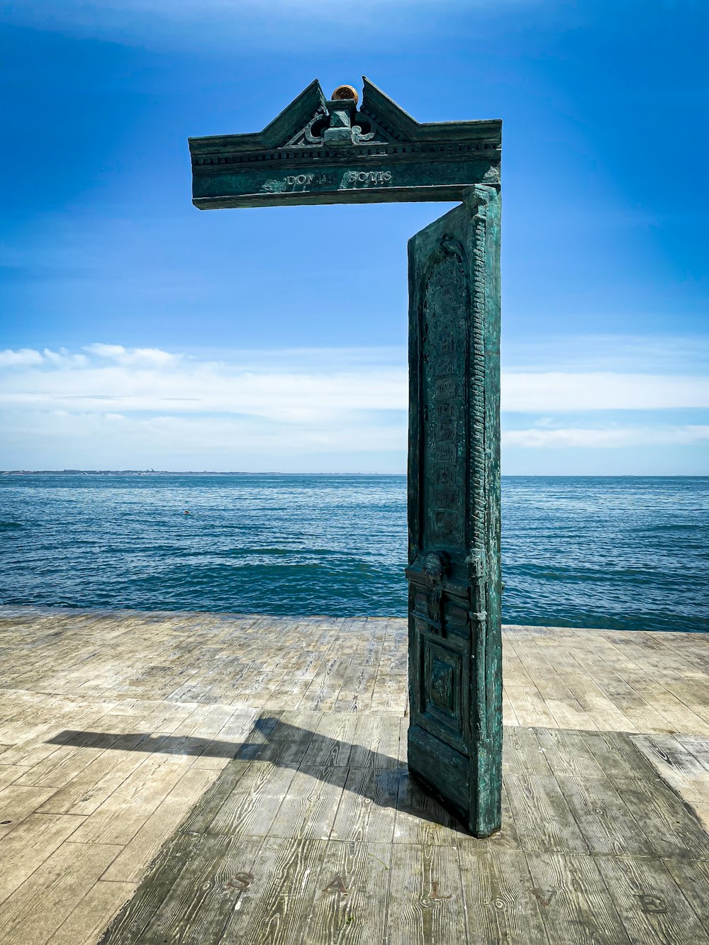 gray concrete cross on beach during daytime