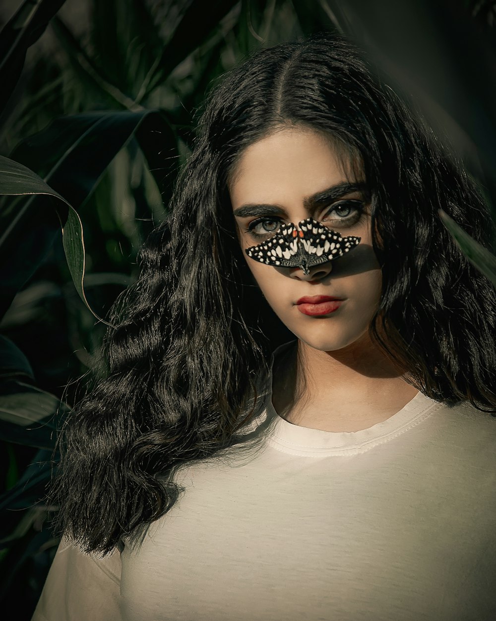 woman in white crew neck shirt with black and white eye mask