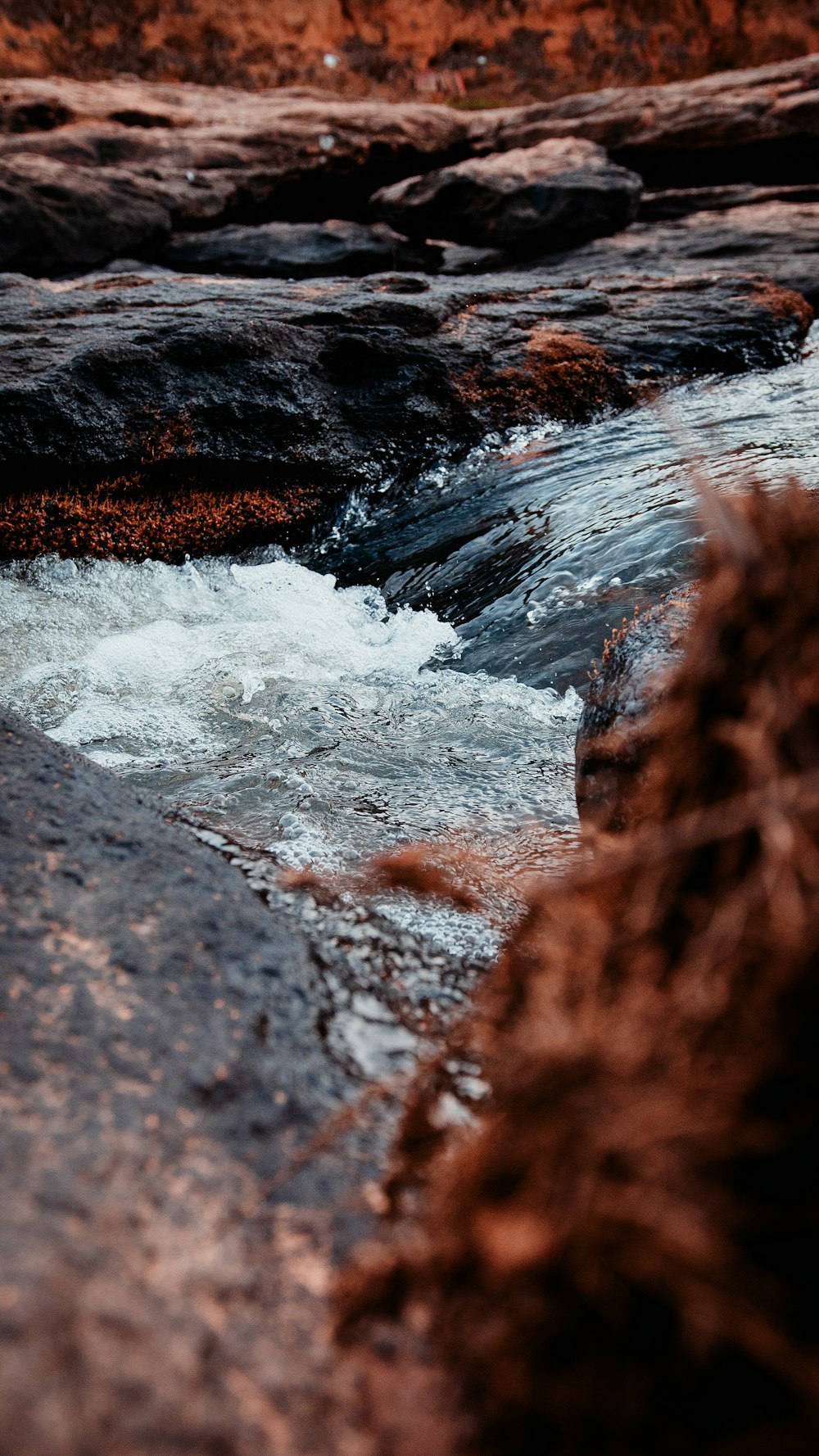 water falls on brown rock