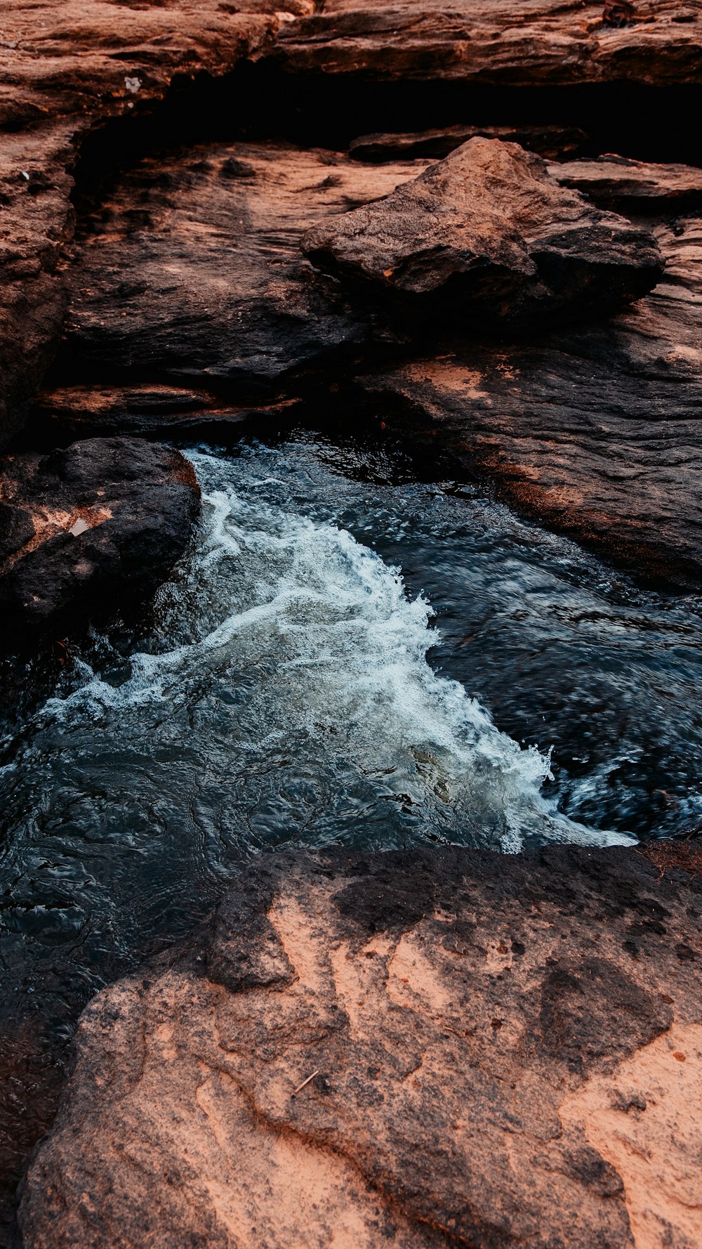 water waves hitting brown rock