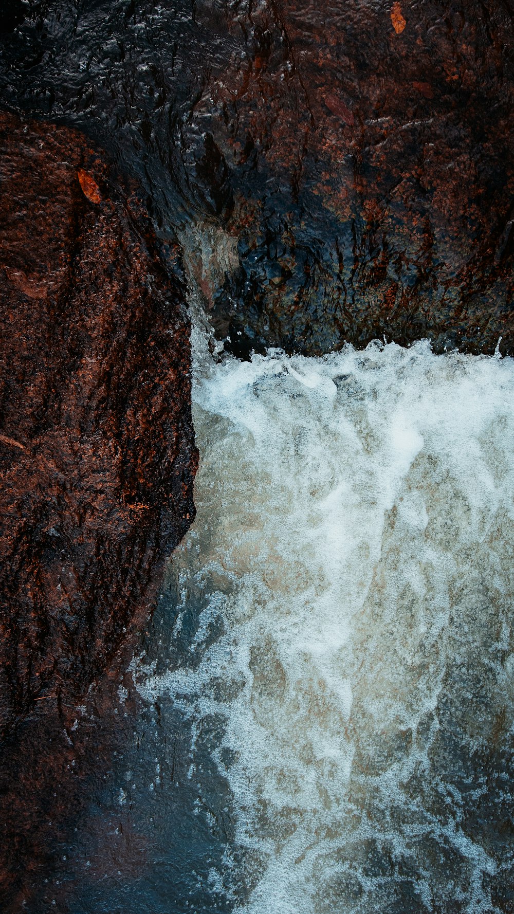 water waves hitting brown rock