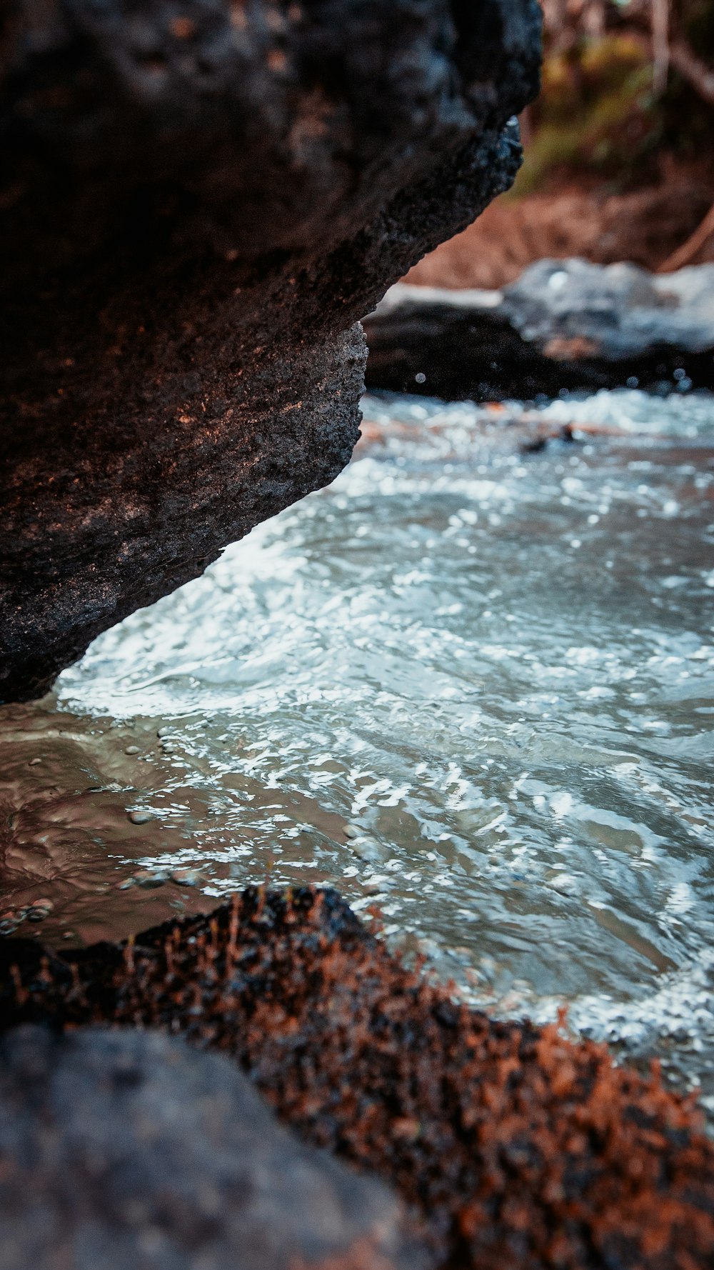 water waves hitting brown rock