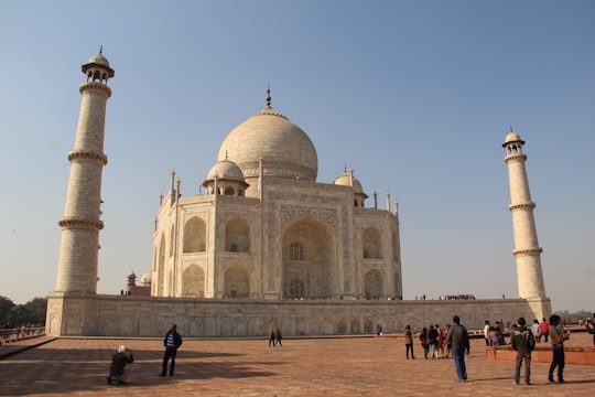 people walking near white concrete building during daytime in Agra Fort India