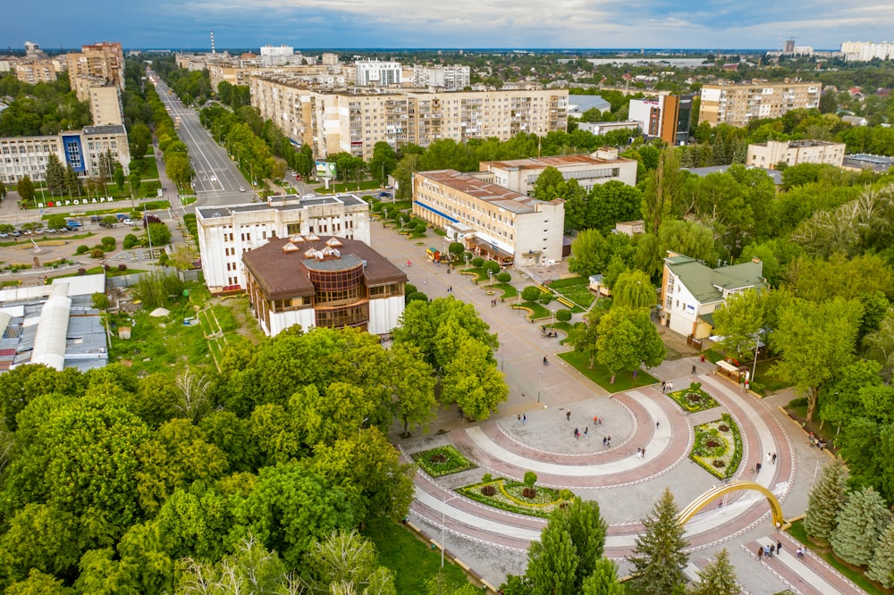 aerial view of green trees and brown and white concrete buildings during daytime