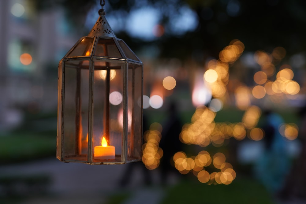 selective focus photography of lighted candle lantern