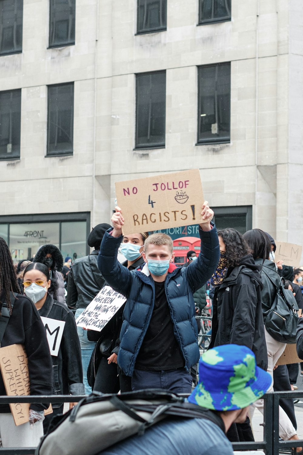 people in blue jacket holding blue banner