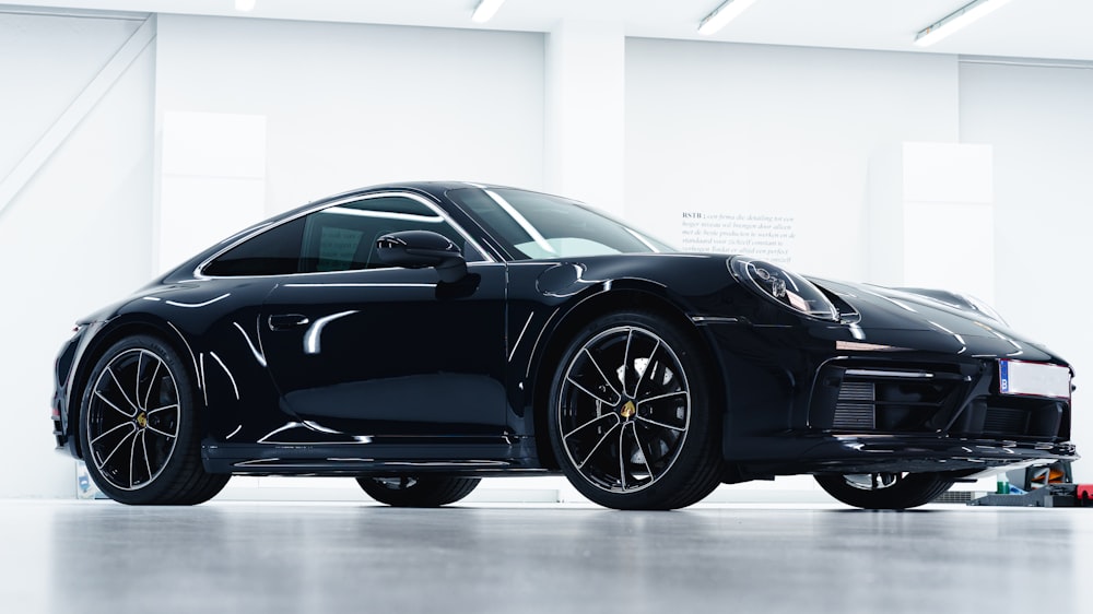 black porsche 911 parked in a room