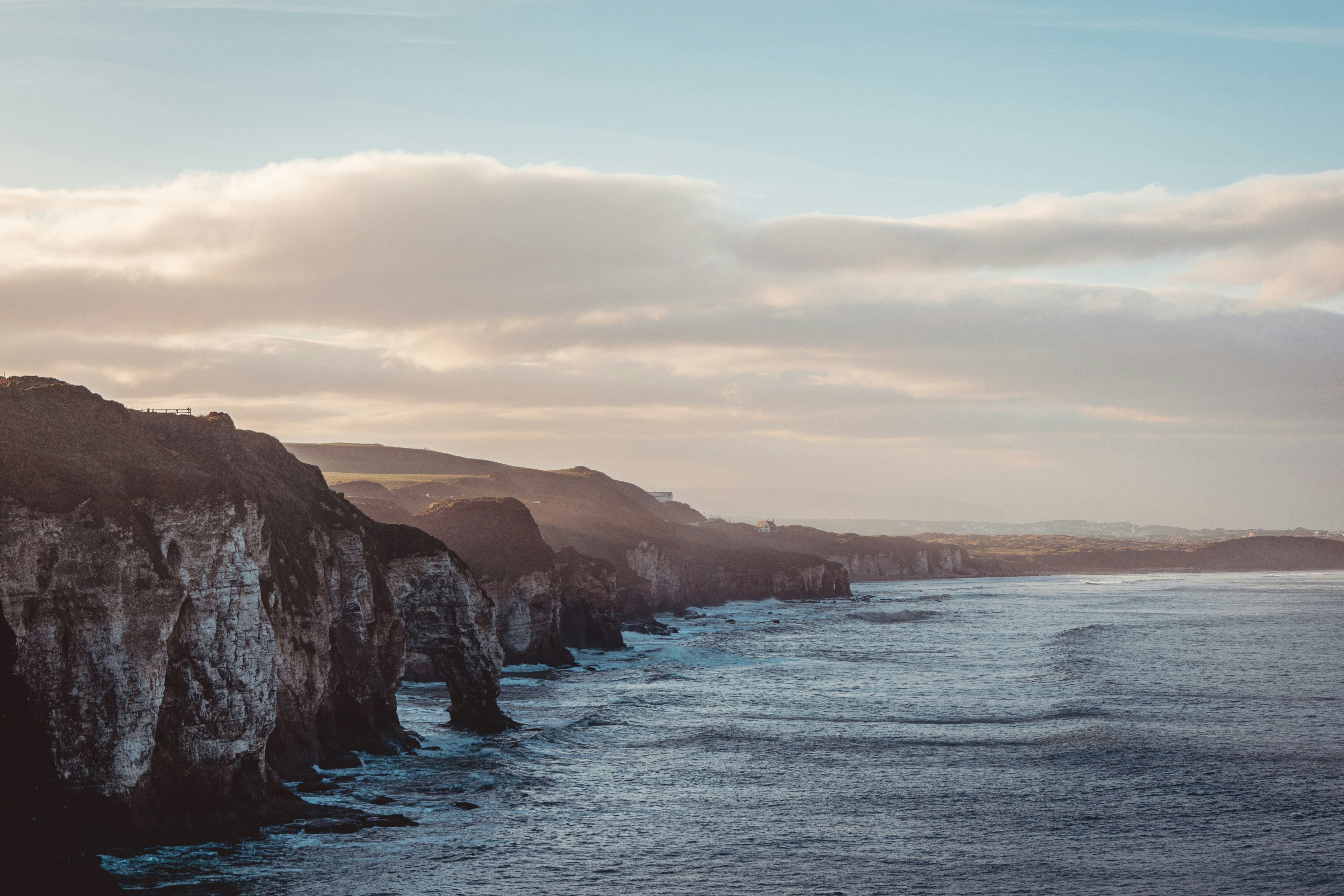 brown and green mountain beside body of water during daytime, 