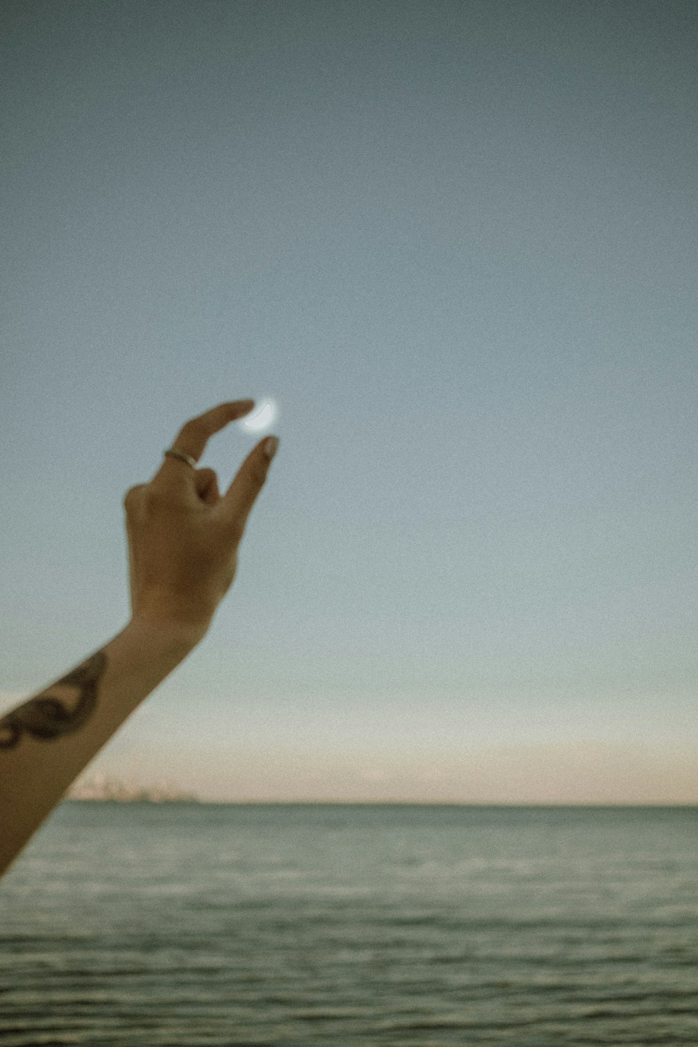 persons hand with blue sky