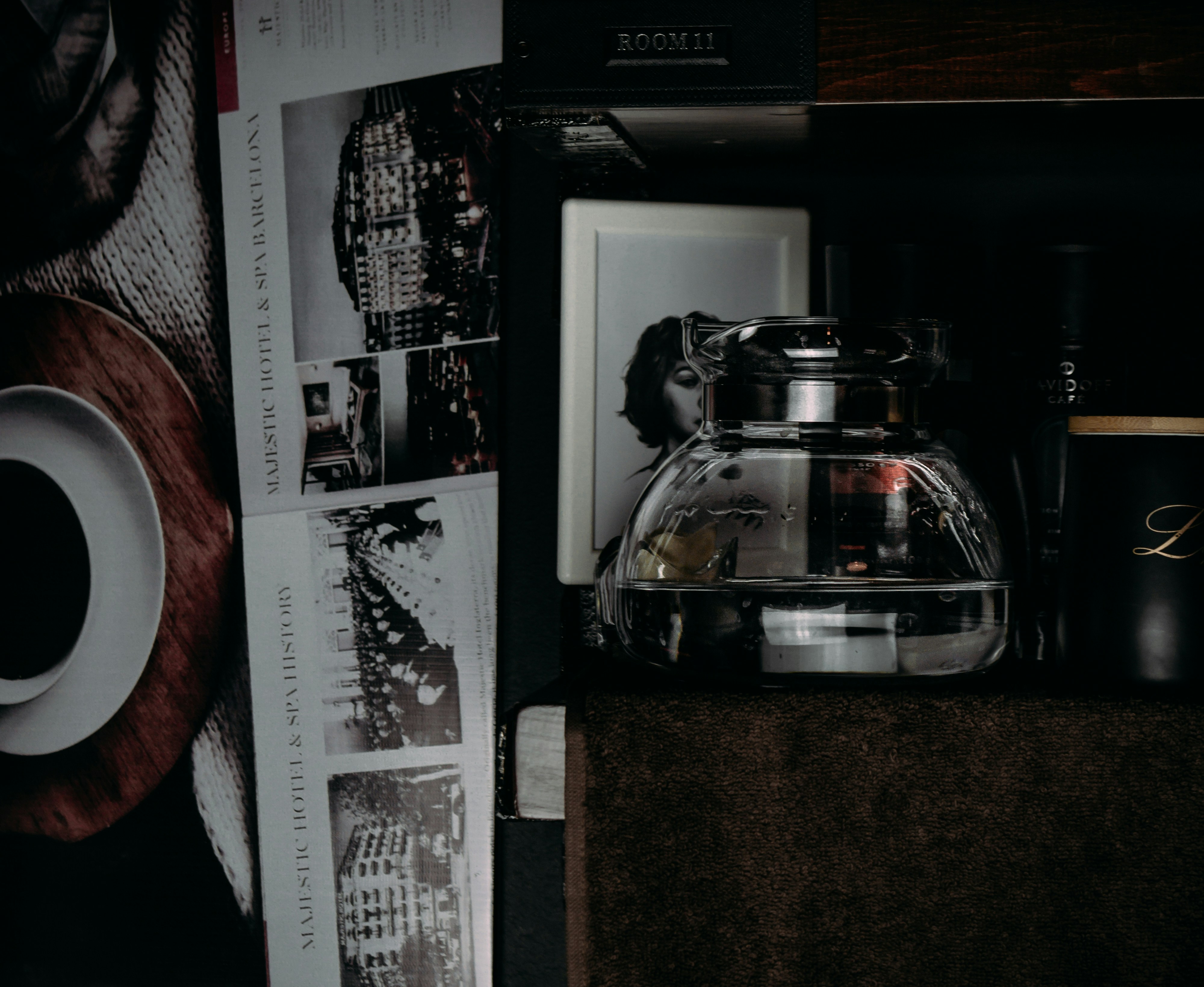 Black wall shelf with glass pot and cup