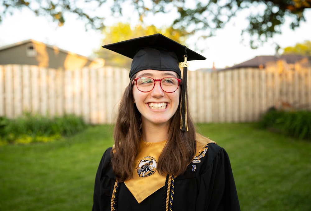 smiling woman in academic dress wearing academic hat