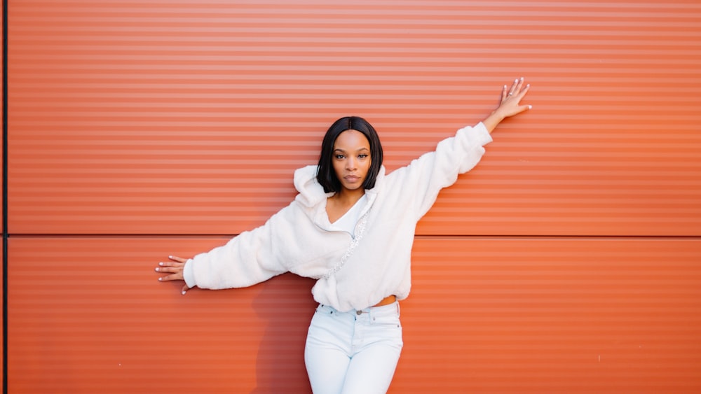 woman in white long sleeve shirt and blue denim jeans