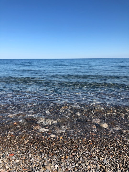 blue sea under blue sky during daytime in Lake Ontario Canada