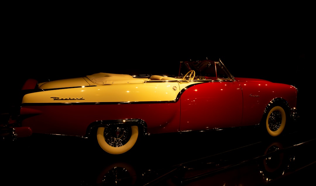 vintage yellow convertible coupe on black background