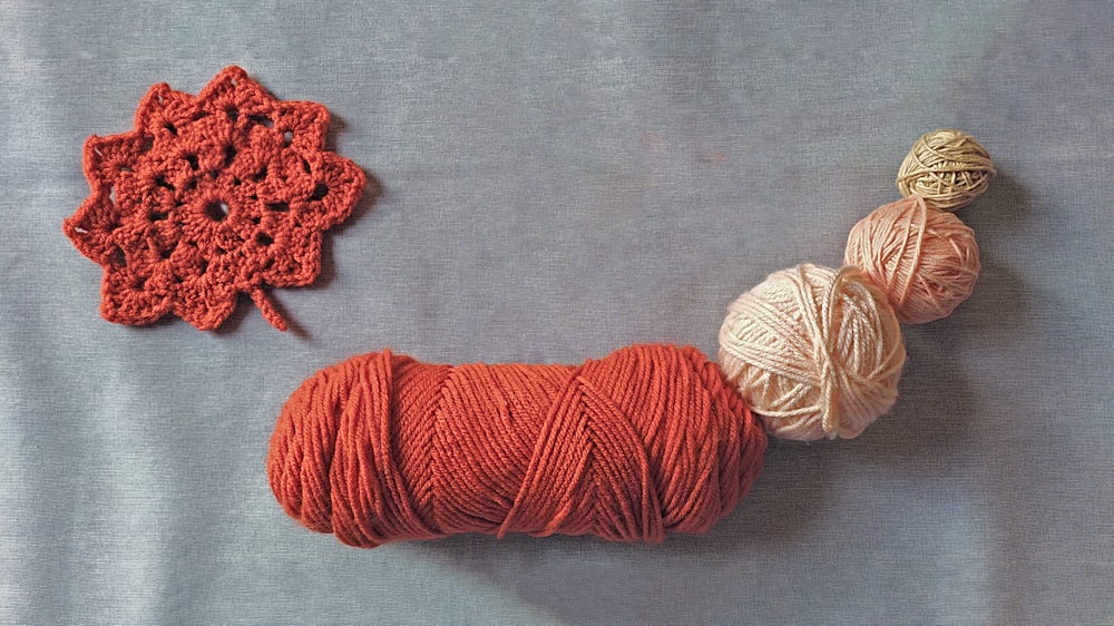 red and white yarn on gray textile