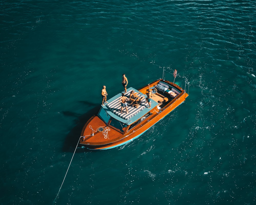 man in green shirt riding on brown and white boat during daytime