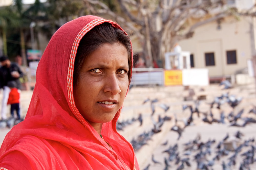 woman in red hijab standing on snow covered ground during daytime