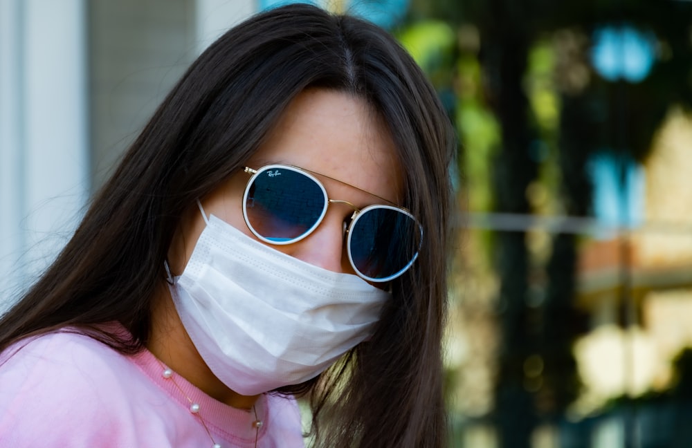 woman in pink shirt wearing white mask