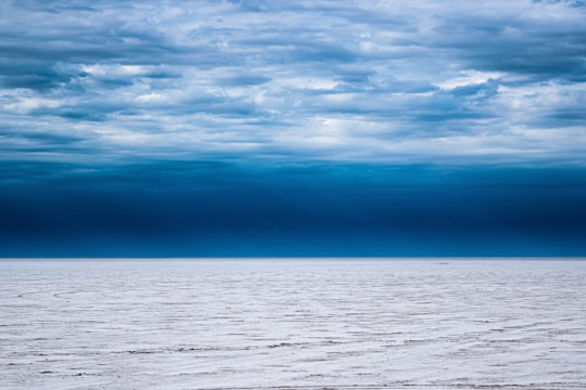 body of water under cloudy sky during daytime in Salinas Grandes Argentina