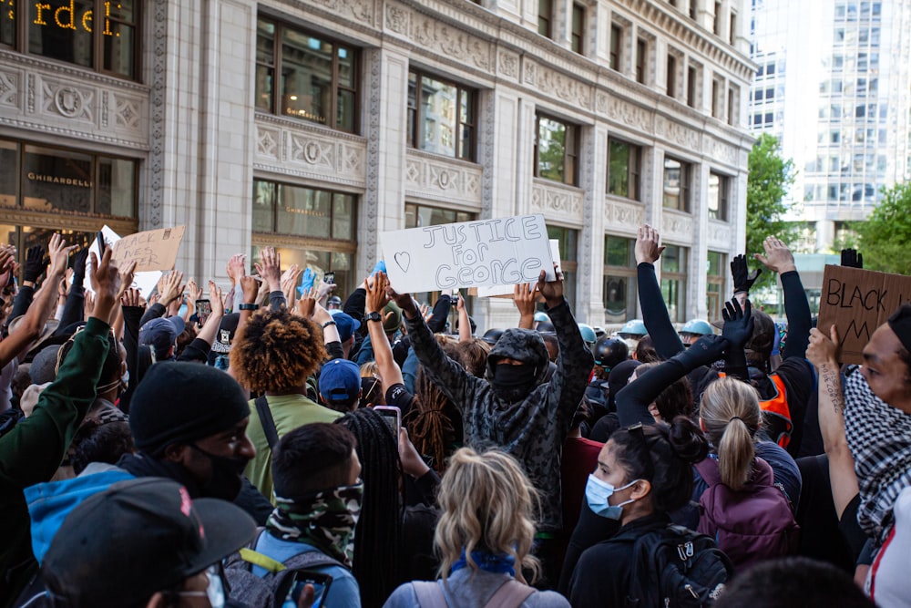 people gathering in front of building during daytime