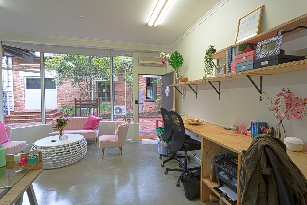 black office rolling chair beside brown wooden desk