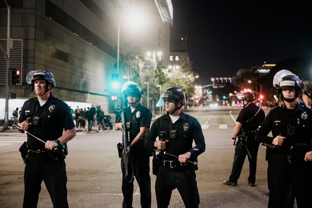 man in black shirt and pants holding black dslr camera