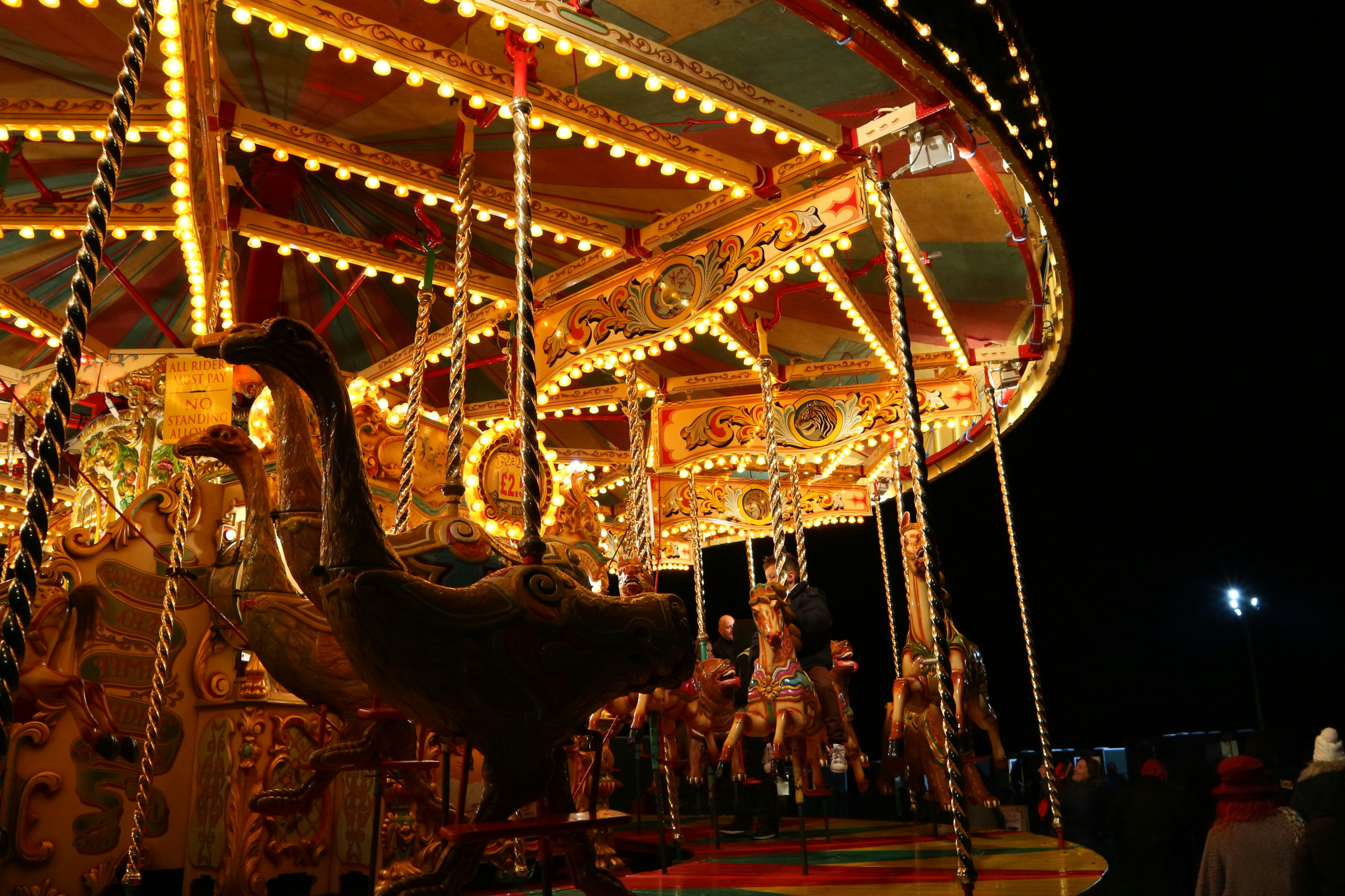 people riding on carousel during night time