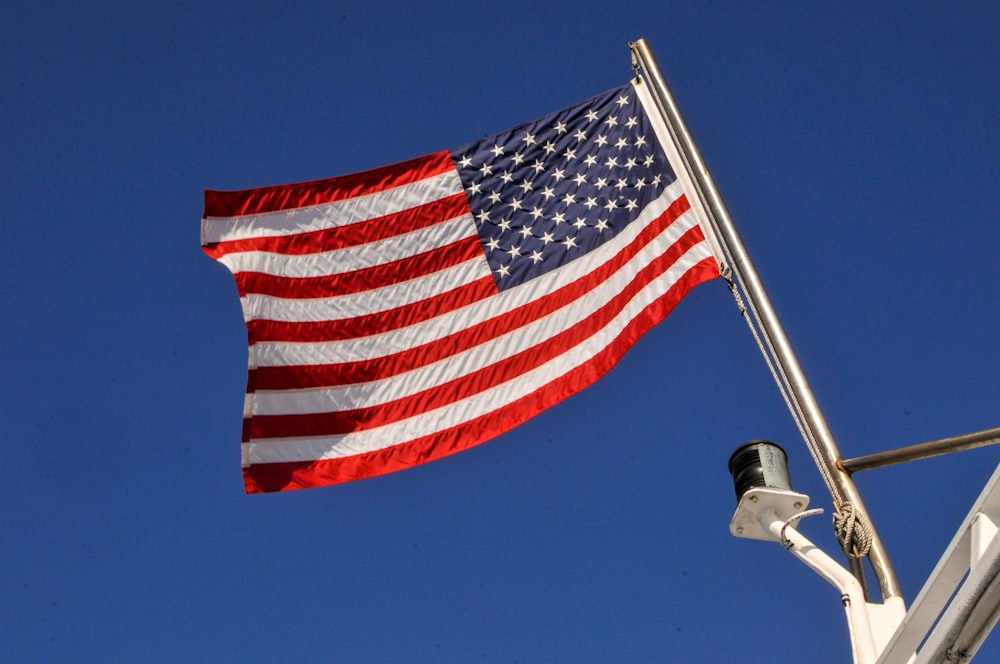 us a flag on pole during daytime