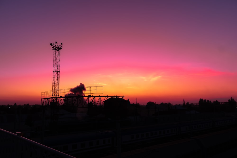 silhouette of trees and buildings during sunset