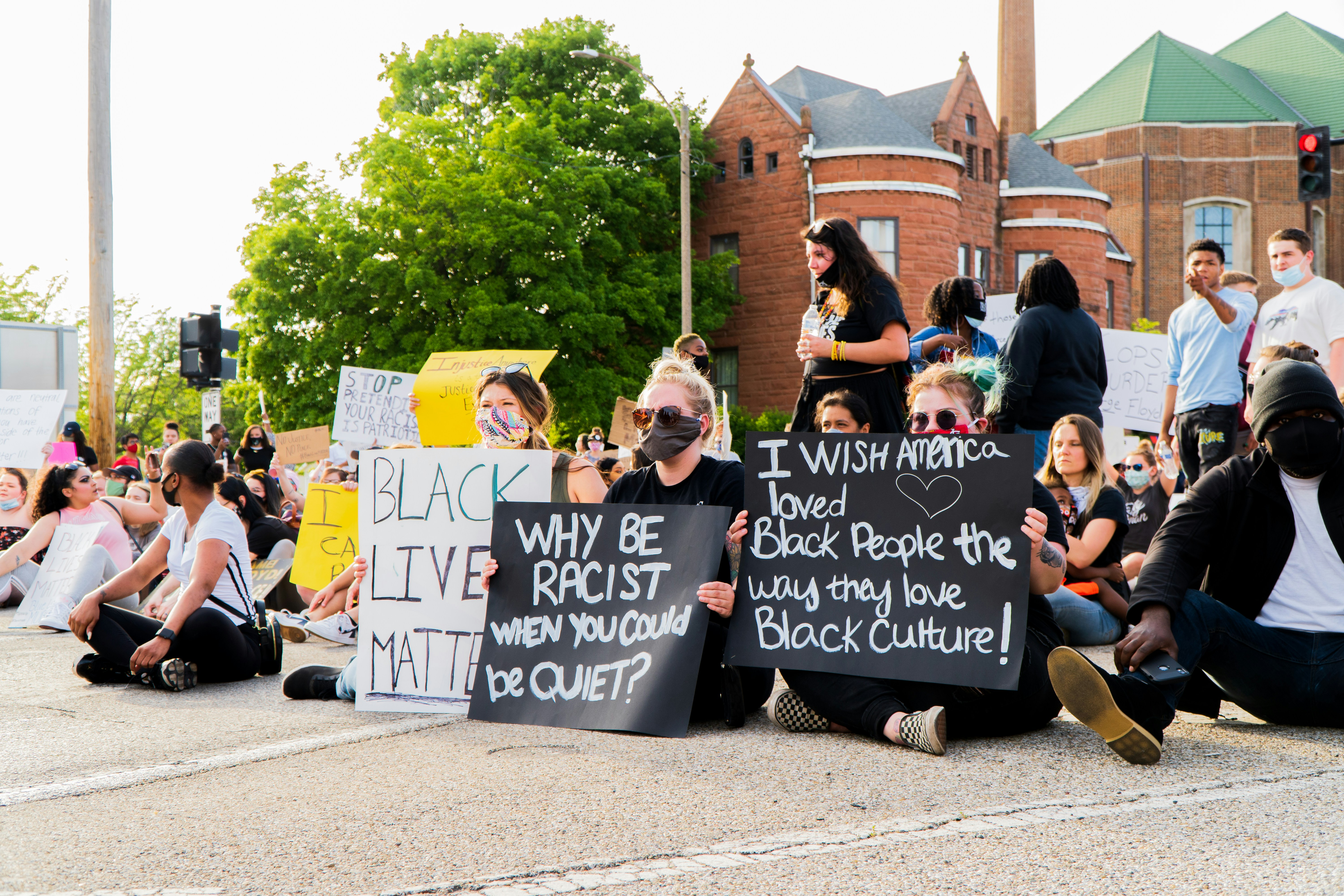 people holding black and white signage