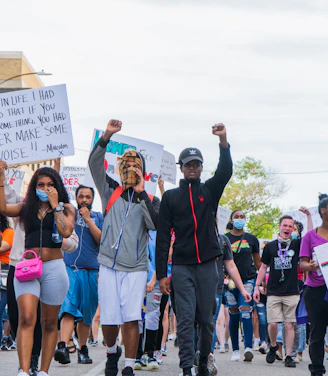 A diverse group of individuals gathered in a community meeting, passionately discussing justice.