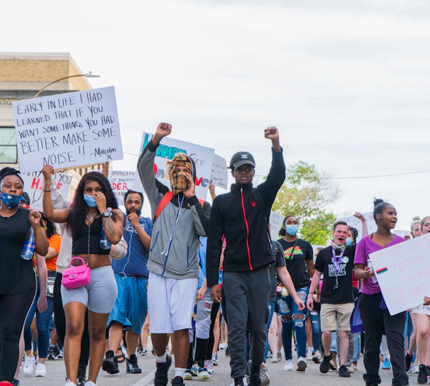 A diverse group of individuals gathered in a community meeting, passionately discussing justice.