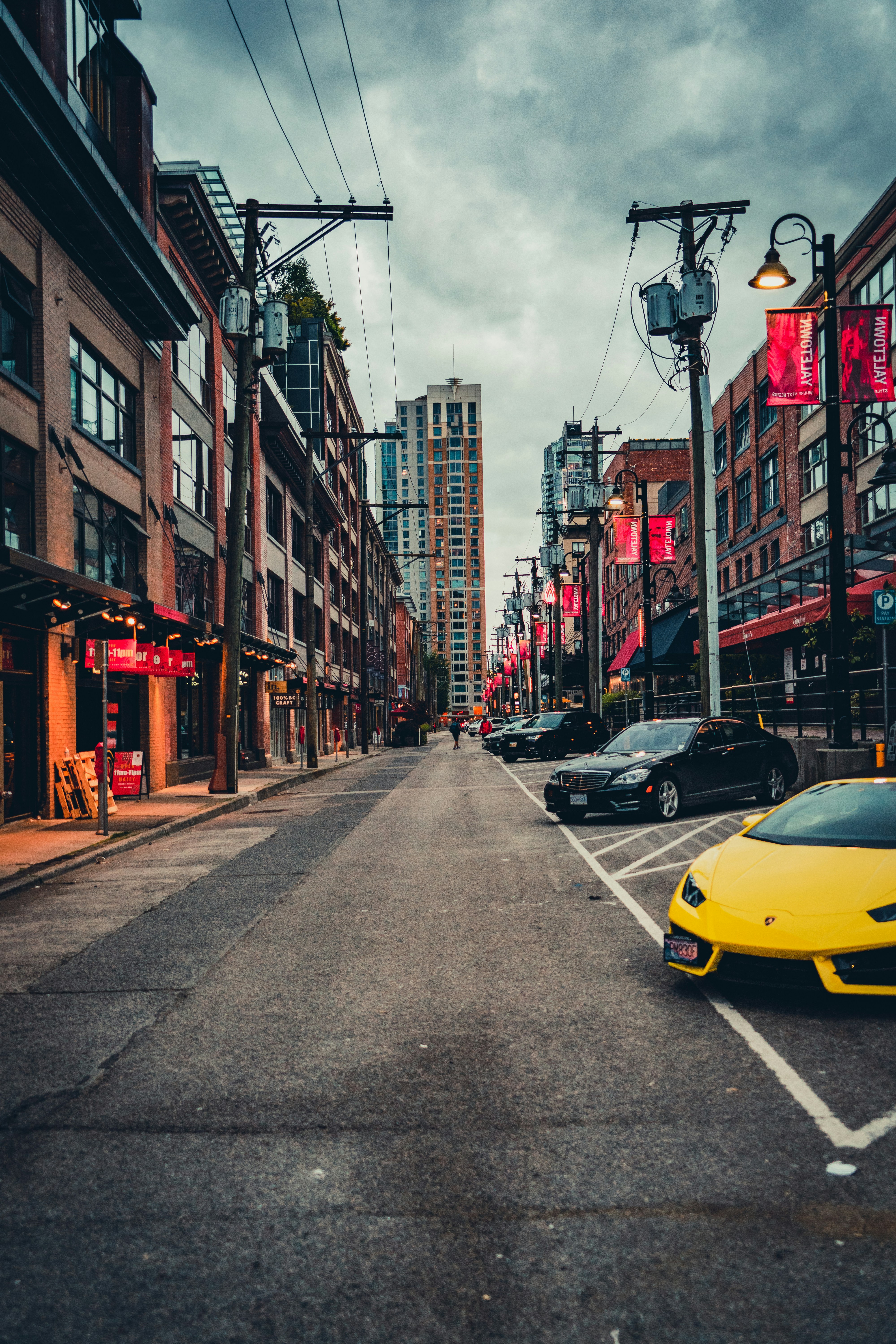 Yellow Lamborghini Huracán on open highway, dramatic sky, wide cinematic angle