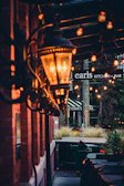 Evening scene of the outdoor kitchen island glowing warmly under string lights.