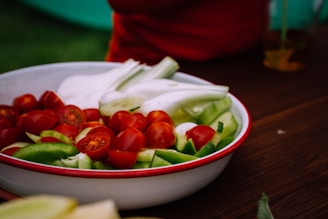 Close-up of a wooden bowl filled with fresh vegetables on a rustic countertop