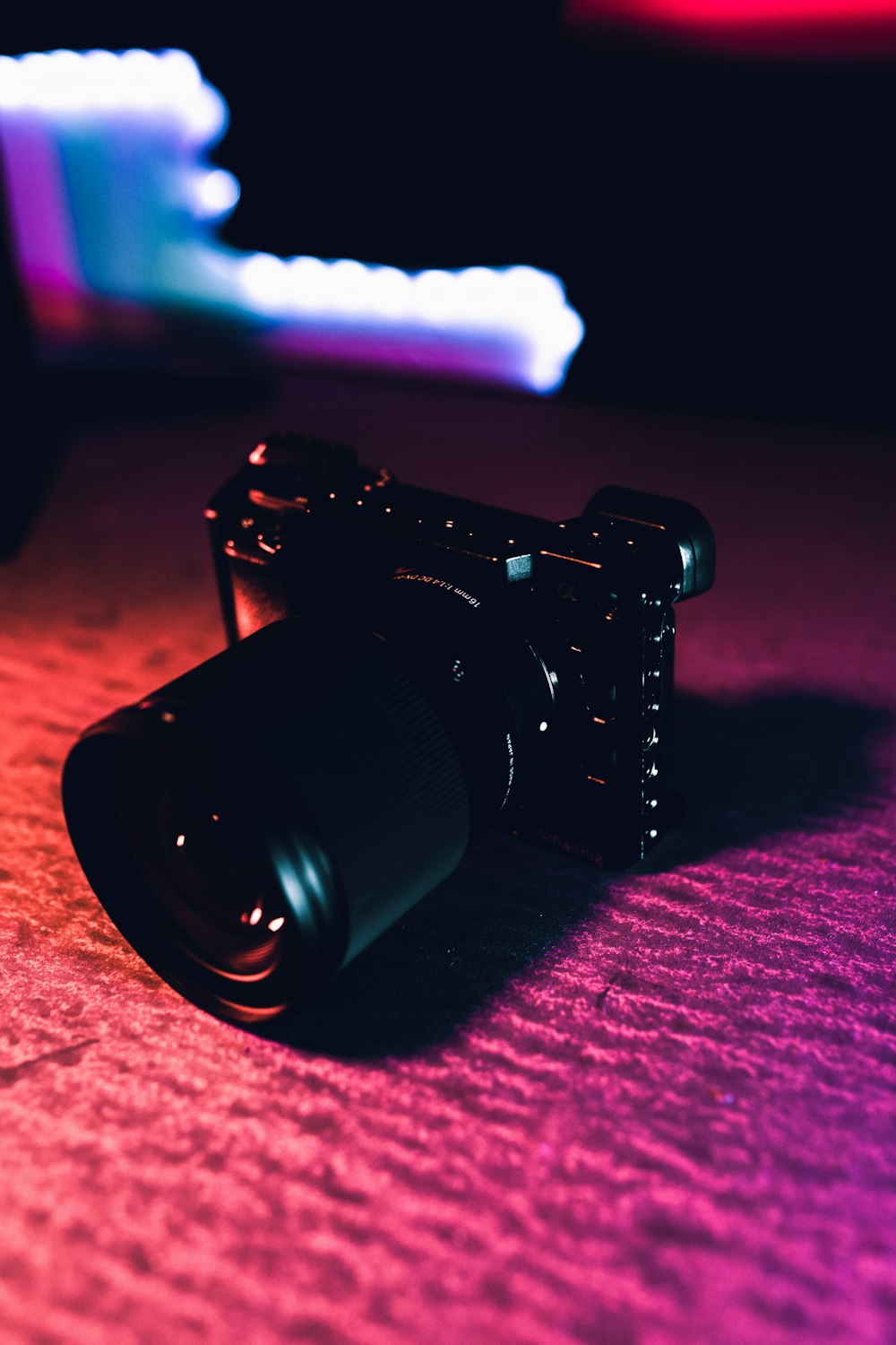 black dslr camera on red textile