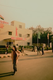 woman in brown dress walking on sidewalk during daytime