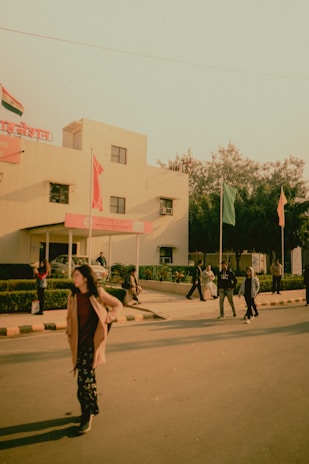 woman in brown dress walking on sidewalk during daytime