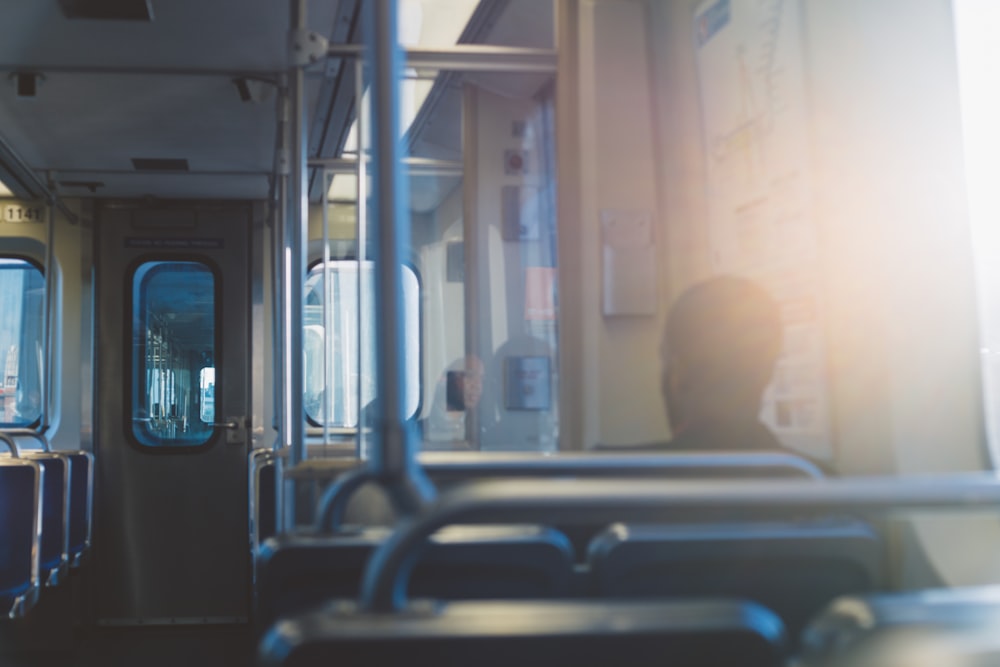 man in white shirt sitting on train seat